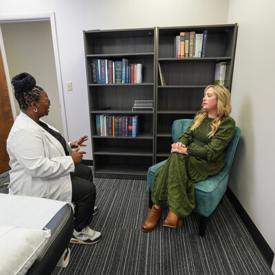 Acupuncturist speaking with a patient about their treatment plan